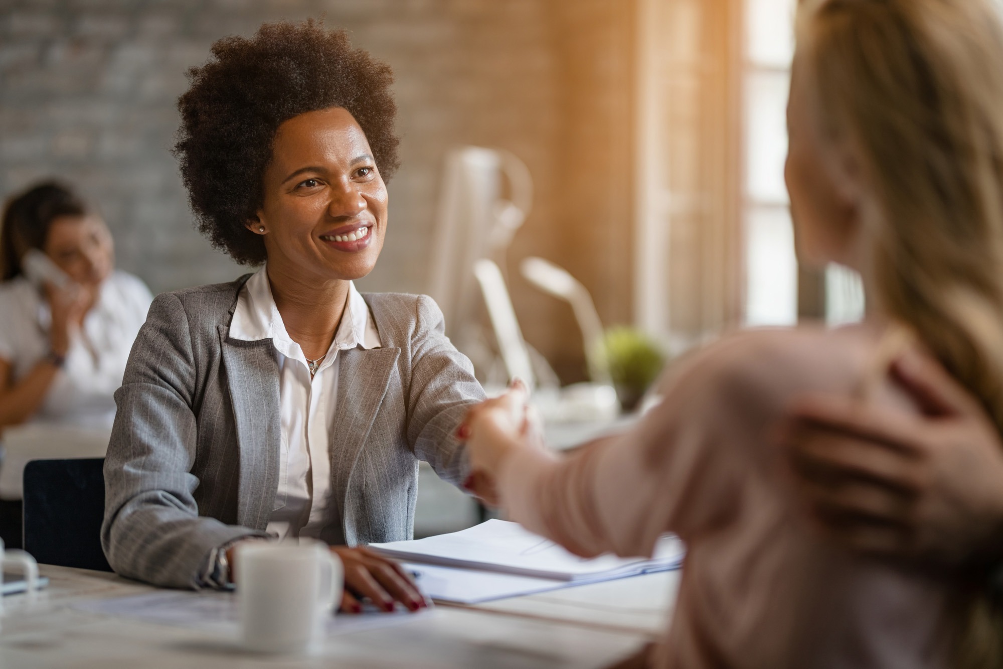 Two women shaking hands