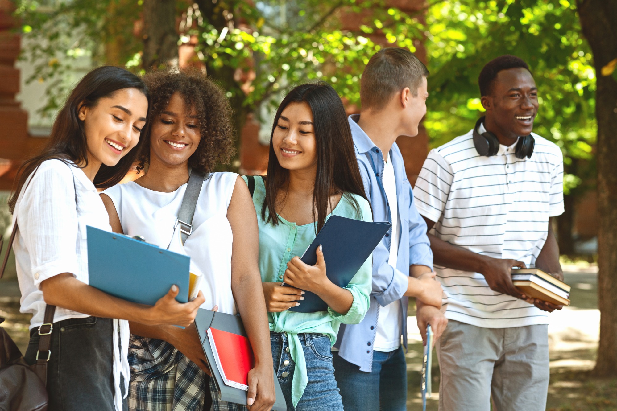 Group of international students resting in campus outdoors